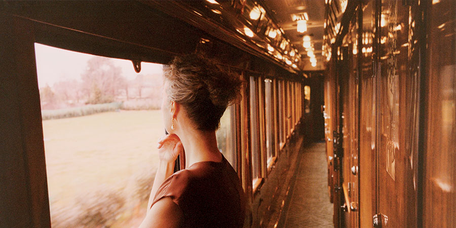 A woman looks out of the window of the Venice Simplon-Orient-Express.